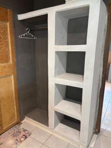 a built in book shelf in a closet at Farm Apartment in Stampriet
