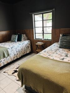 a bedroom with two beds and a window at Farm Apartment in Stampriet