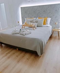 a bedroom with a large bed with a table on it at Casa Petrí Home SPA in Palermo
