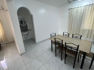 a dining room with a table and chairs and a toilet at Sun Park Malindi - Back Villa - Black Pearl in Malindi +16 photos
