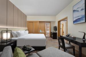 Ένα ή περισσότερα κρεβάτια σε δωμάτιο στο Wyndham Garden Haikou Meilan +50 φωτογραφίες
