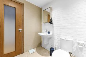 a bathroom with a toilet and a sink and a mirror at Zone 1, Family Friendly, 2 Beds, Central London in London