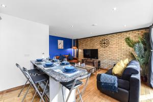 a living room with a table and a couch at Zone 1, Family Friendly, 2 Beds, Central London in London