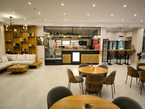 a restaurant with tables and chairs and a kitchen at Beautiful Apartment in Bansko
