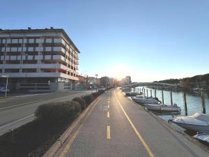 a street with boats parked next to a building at Capitol Apartments in Grado