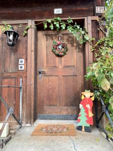 a door with a teddy bear and a christmas tree on it at Private Apartment in Guesthouse Rosalie in Brunnadern