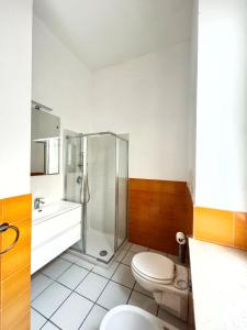 a bathroom with a shower and a toilet and a sink at Mediterranea Residence in Salerno