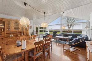 a kitchen and living room with a table and chairs at Lovely Holiday Home By The Limfjord in Storvorde
