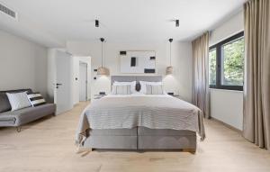 - une chambre blanche avec un grand lit et un canapé dans l'établissement Cozy Home In Icici With Sauna, à Ičići