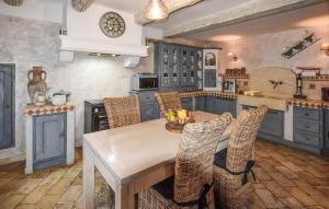 a kitchen with a wooden table and chairs at 2 Bedroom Lovely Home In Vedène in Vedène