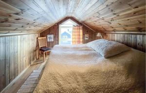 a bedroom with a bed in a room with a window at Cozy Home In Sjusjøen With Sauna in Sjusjøen +8 photos