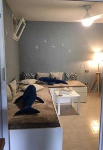 a living room with two beds and a couch at Monte Isoliana - petit paradis in Monte Isola