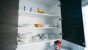 a cupboard filled with plates and bowls and dishes at Cuchillos de la fonseca in Casas de Moya