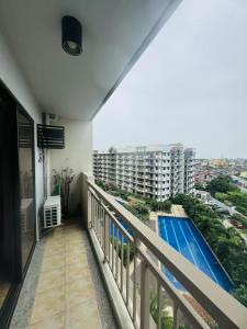 a balcony with a view of a swimming pool at Alea Residence 21 in Manila