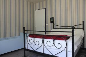 Un dormitorio con una cama con una manta roja y blanca. en Villa du Bac, en Chambon-sur-Lac