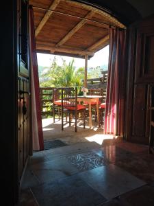 an open door to a patio with a table and chairs at El Chorrillo in Alcuéscar