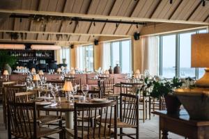 a dining room with tables and chairs and windows at Copenhagen Admiral Hotel in Copenhagen