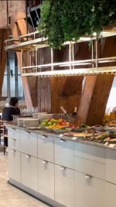 a kitchen with a counter with fruits and vegetables at Copenhagen Admiral Hotel in Copenhagen
