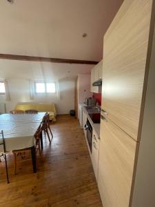 a kitchen and dining room with a table and chairs at joli T3 au coeur de lourdes in Lourdes