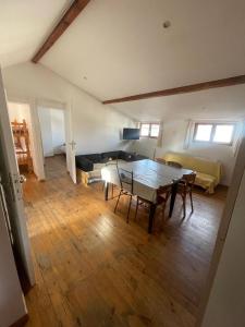 a living room with a table and a couch at joli T3 au coeur de lourdes in Lourdes