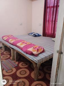 a bed in a room with a blanket on it at Mahavir home stay in Prayagraj