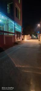 an empty parking lot in front of a building at night at Shree dham home stay in Faizābād