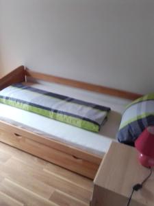 a bed with a wooden frame in a room at Ferienwohnung In Zandt Mit Garten Und Grill in Zandt
