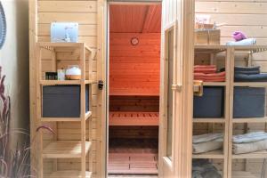 a sauna with a door open in a room at Ferienhaus Maifelder Wellness Loft In Gappenach in Gappenach