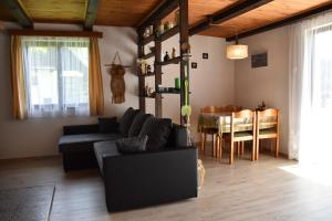 a living room with a couch and a dining room at Chata s výhledem do údolí Frymburk, Náhlov in Frymburk