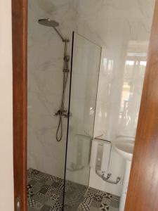 a bathroom with a shower and a toilet at Cristina's Holiday Home in Tagaytay