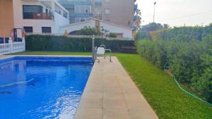 a chair sitting next to a swimming pool at Balcones del Mar By Solymar Holiday in Torrox Costa