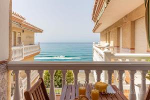 a table on a balcony with a view of the ocean at Balcones del Mar By Solymar Holiday in Torrox Costa