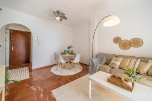 a living room with a couch and a table at Balcones del Mar By Solymar Holiday in Torrox Costa +37 photos