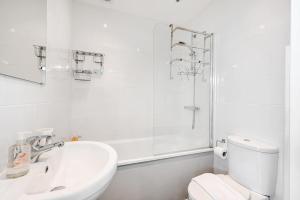 a white bathroom with a sink and a toilet at Host & Stay - Blue Bolthole on Vicarage Lane in Rottingdean