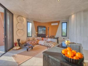 a living room with a couch and a bowl of oranges at The Ekipa in Okaukuejo