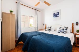 a bedroom with a bed with a blue blanket at Apartamento CASTELLSOL 201 by Mauter Villas in Arenal d'en Castell +11 photos
