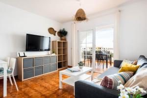 a living room with a couch and a tv at Apartamento CASTELLSOL 201 by Mauter Villas in Arenal d'en Castell