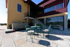 a patio with a table and chairs in front of a building at Ferienhaus Für 12 Personen In Esposende in Esposende