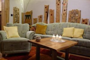 a living room with a couch and a table with candles at Haus Molle in Benneckenstein +32 photos