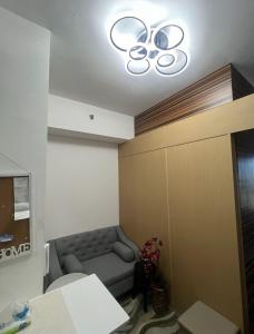 a waiting room with a couch and a light at Luxury for Less next to BGC and Makati CBD in Manila