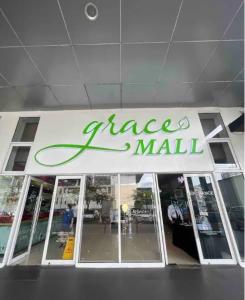 a large mall sign on the front of a building at Luxury for Less next to BGC and Makati CBD in Manila