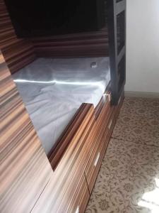 a bed in a room with a wooden cabinet at Luxury for Less next to BGC and Makati CBD in Manila
