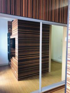 a room with a wall of wooden closet doors at Luxury for Less next to BGC and Makati CBD in Manila