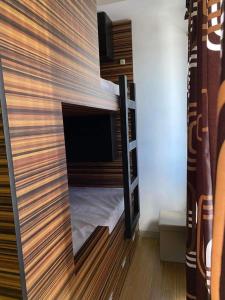 a room with a bunk bed with a tv in it at Luxury for Less next to BGC and Makati CBD in Manila