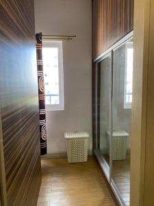 a room with a glass door and a window at Luxury for Less next to BGC and Makati CBD in Manila