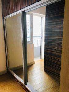 a large sliding glass door in a room with a window at Luxury for Less next to BGC and Makati CBD in Manila