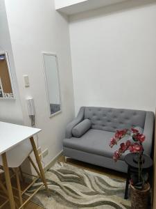a living room with a blue couch and a table at Luxury for Less next to BGC and Makati CBD in Manila