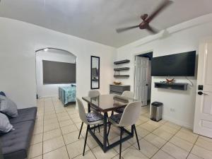 a living room with a table and chairs and a couch at A Little Bit Of Paradise Ground Floor Studio in Coco
