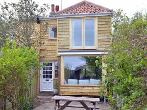 a tiny house with a picnic table in front of it at Fen Cottage, Walberswick in Walberswick