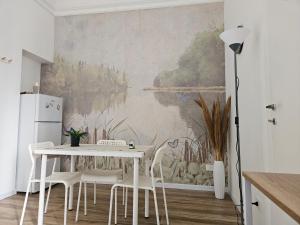 a dining room with a white table and chairs at Sofia's Central Apartment Palermo in Palermo